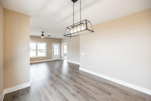 interior space with ceiling fan and wood-type flooring