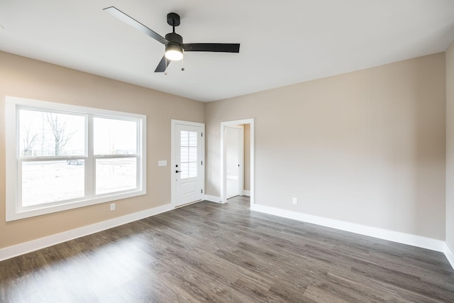 unfurnished room with ceiling fan and dark hardwood / wood-style flooring