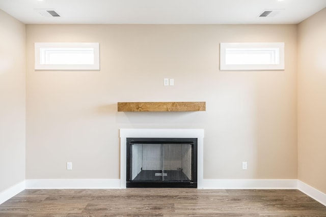 room details with hardwood / wood-style floors and a fireplace