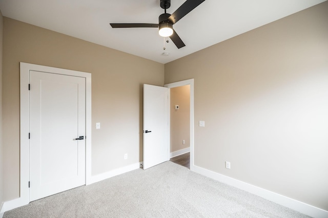 unfurnished bedroom featuring carpet flooring and ceiling fan