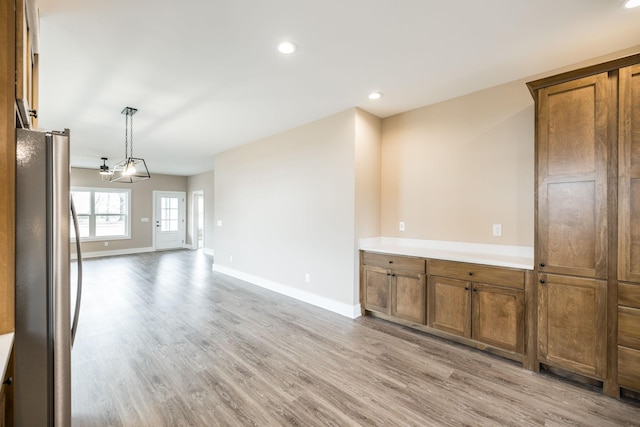 interior space with light wood-type flooring and an inviting chandelier