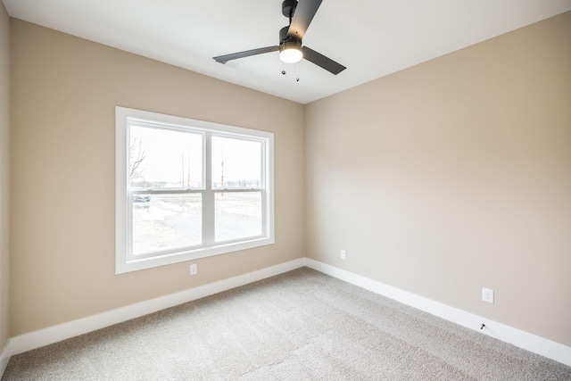 carpeted empty room featuring ceiling fan