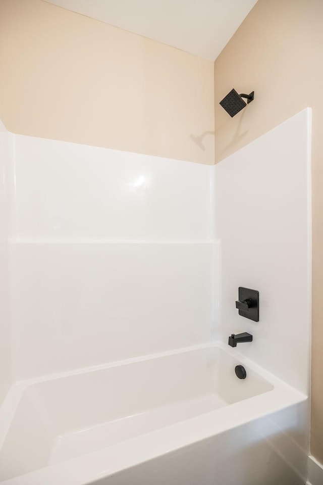 bathroom with bathing tub / shower combination