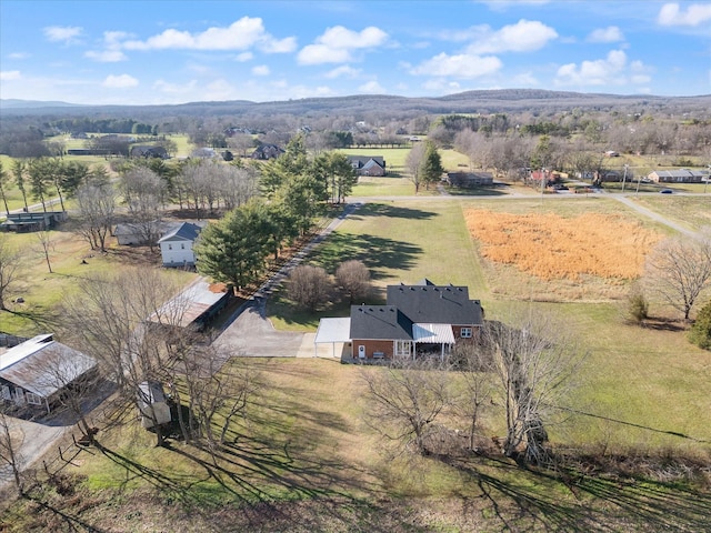 birds eye view of property with a rural view