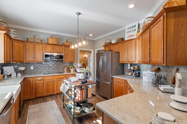 kitchen featuring backsplash, dark wood-type flooring, hanging light fixtures, light stone countertops, and appliances with stainless steel finishes