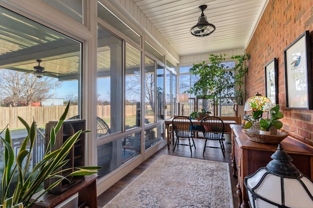 sunroom featuring ceiling fan