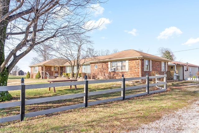 view of front of property featuring a front lawn and cooling unit