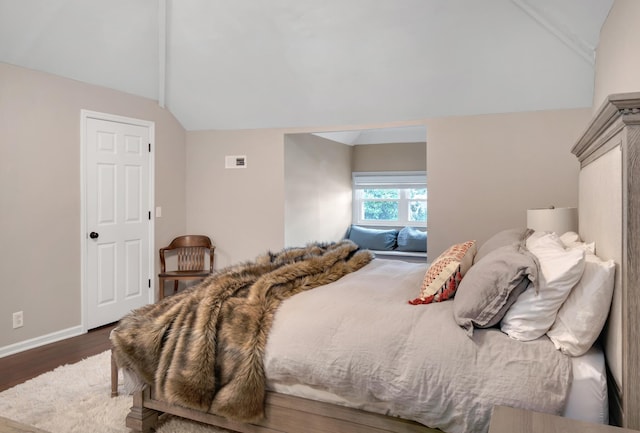 bedroom with dark hardwood / wood-style flooring and lofted ceiling