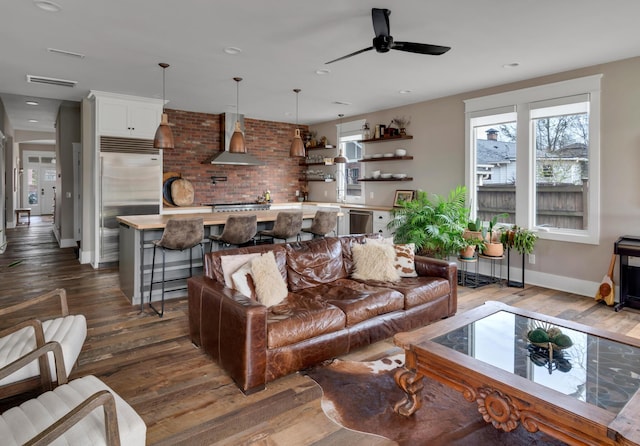 living room with ceiling fan and dark wood-type flooring