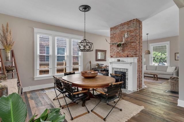 dining room with a healthy amount of sunlight and dark hardwood / wood-style floors