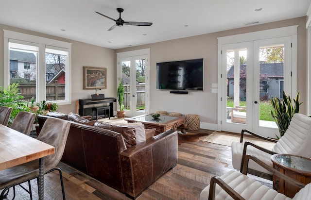 living room featuring french doors, dark hardwood / wood-style flooring, and ceiling fan