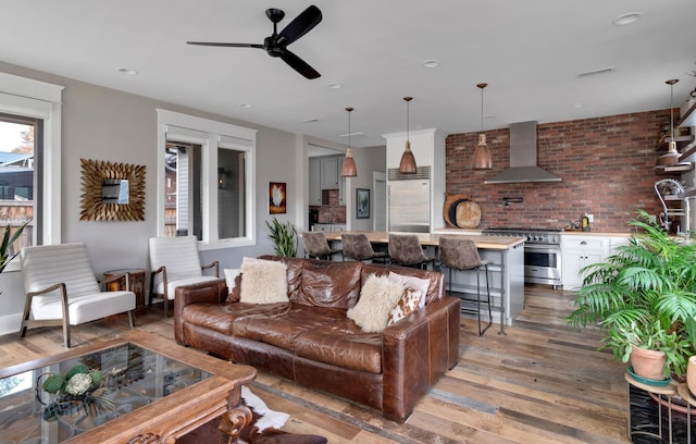 living room with hardwood / wood-style floors and ceiling fan