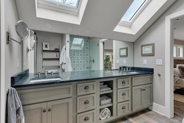 bathroom featuring a shower with door, vanity, wood-type flooring, and vaulted ceiling