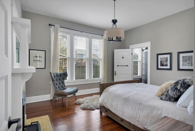 bedroom with dark hardwood / wood-style flooring