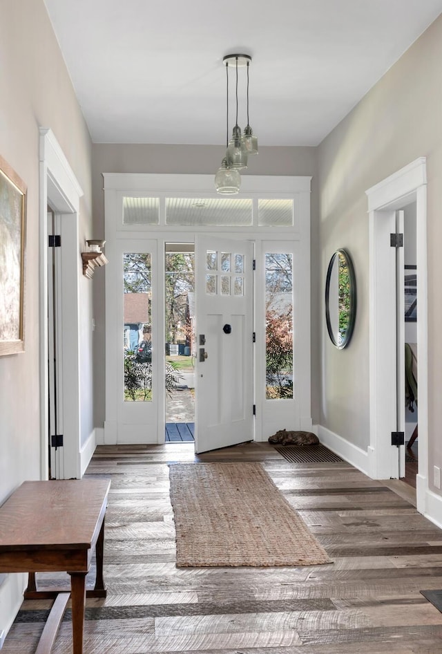 entryway with dark hardwood / wood-style flooring