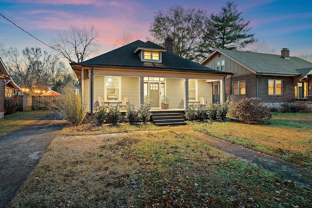 bungalow-style house with a yard and a porch