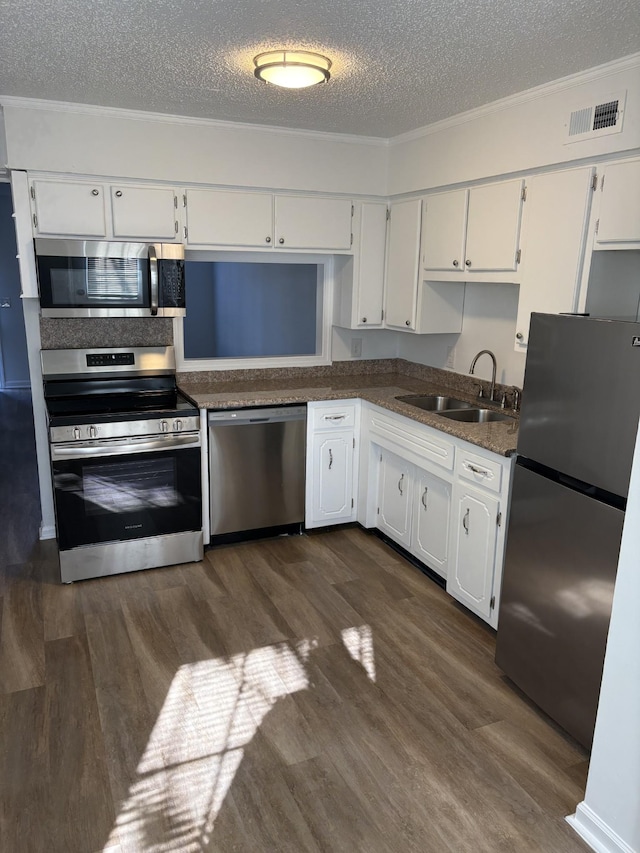 kitchen featuring white cabinets, sink, stainless steel appliances, and a textured ceiling