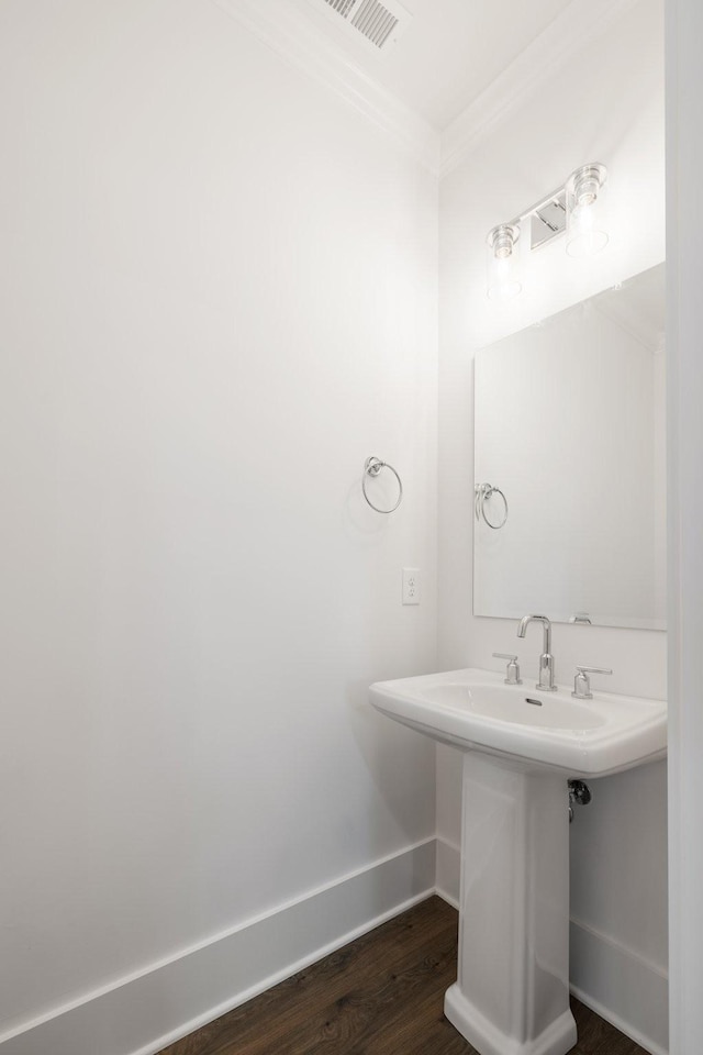 bathroom featuring hardwood / wood-style floors and ornamental molding