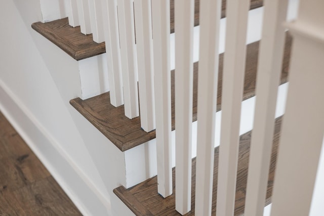 stairway with hardwood / wood-style flooring