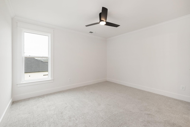 spare room featuring ceiling fan, ornamental molding, and carpet floors