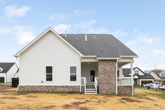 rear view of house featuring covered porch