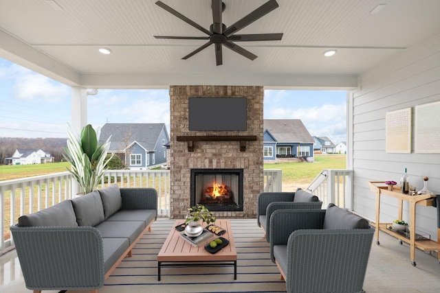 exterior space featuring an outdoor living space with a fireplace and ceiling fan