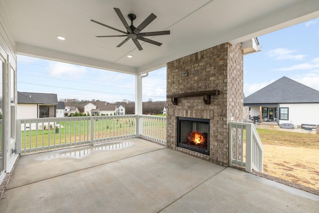 view of patio featuring ceiling fan, a porch, and an outdoor brick fireplace