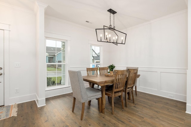 dining space featuring a chandelier, dark hardwood / wood-style flooring, and ornamental molding