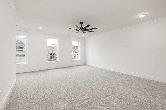 unfurnished room featuring light colored carpet, plenty of natural light, crown molding, and ceiling fan