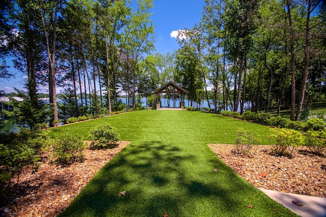 view of yard featuring a gazebo and a water view