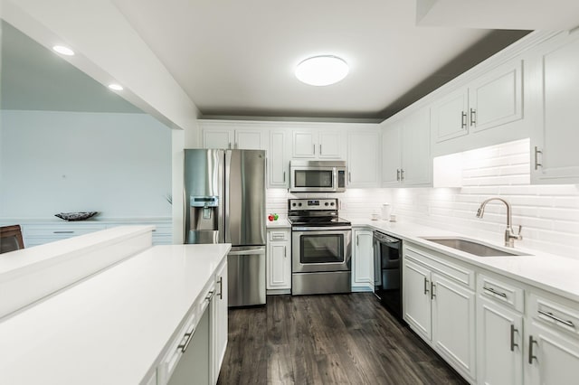 kitchen featuring dark hardwood / wood-style flooring, white cabinetry, sink, and appliances with stainless steel finishes