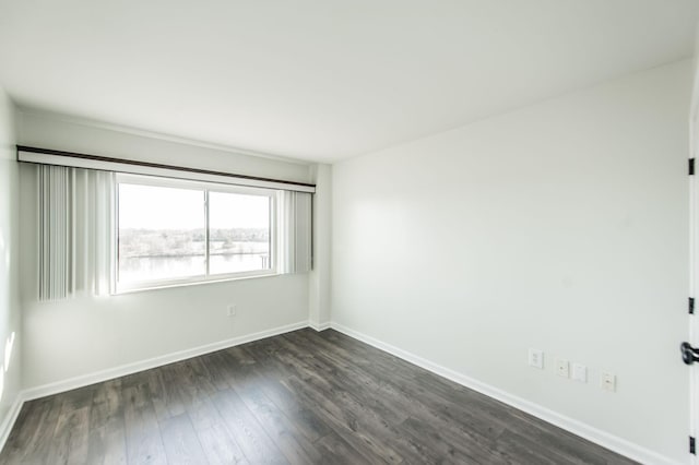 unfurnished room with dark hardwood / wood-style floors