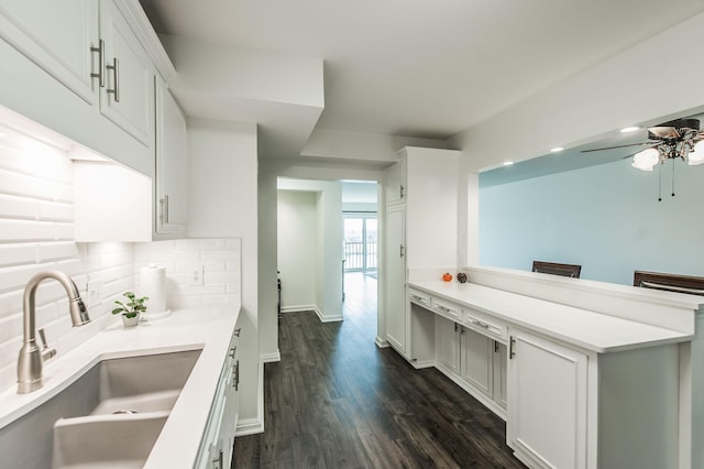 kitchen with white cabinets, sink, decorative backsplash, dark hardwood / wood-style floors, and ceiling fan