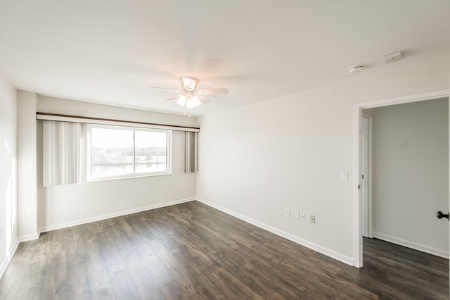 unfurnished room with dark hardwood / wood-style floors and ceiling fan