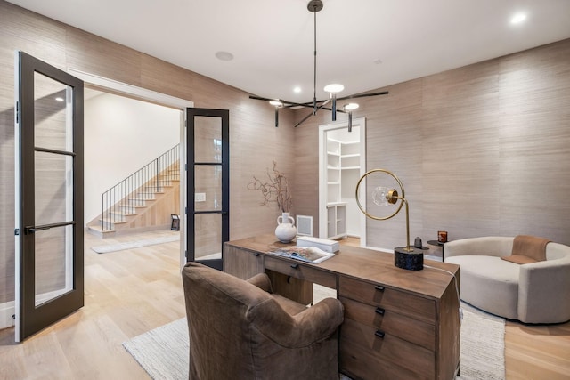 office space with a chandelier and light hardwood / wood-style flooring