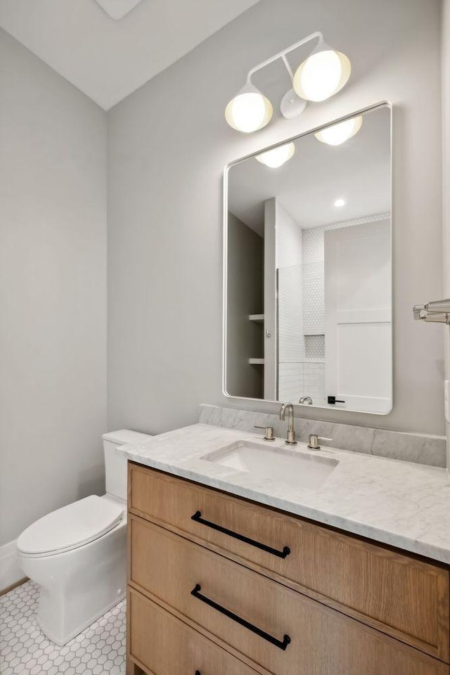 bathroom featuring tile patterned floors, vanity, and toilet