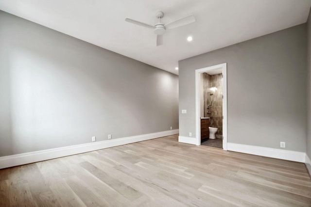 unfurnished bedroom with light wood-type flooring, ensuite bath, and ceiling fan