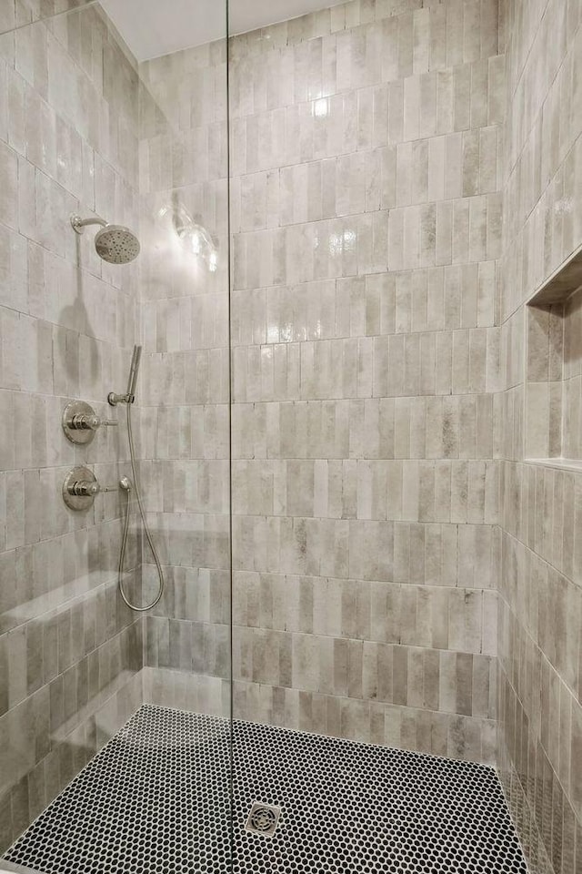 bathroom with a tile shower