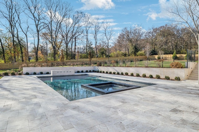 view of pool with an in ground hot tub and a patio