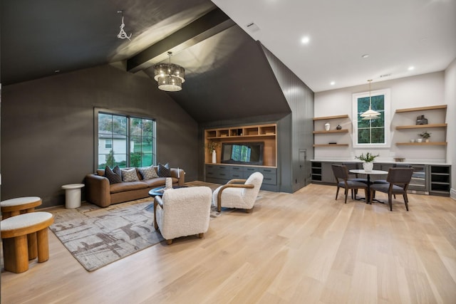 living room featuring a notable chandelier, vaulted ceiling with beams, light hardwood / wood-style floors, and wine cooler