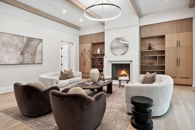 living room with beamed ceiling and light wood-type flooring