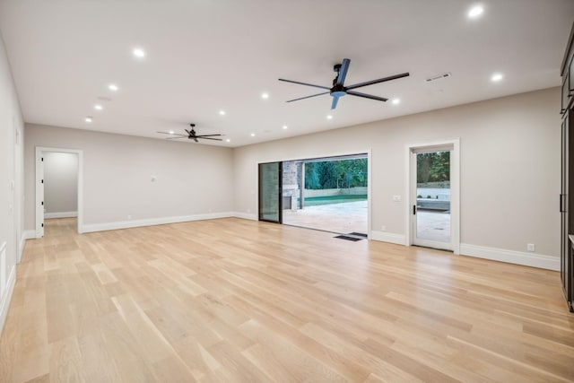 unfurnished living room featuring light wood-type flooring and ceiling fan