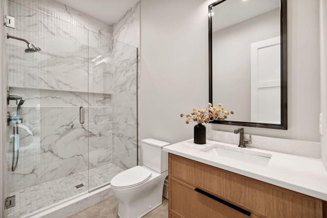 bathroom featuring tile patterned flooring, vanity, toilet, and walk in shower