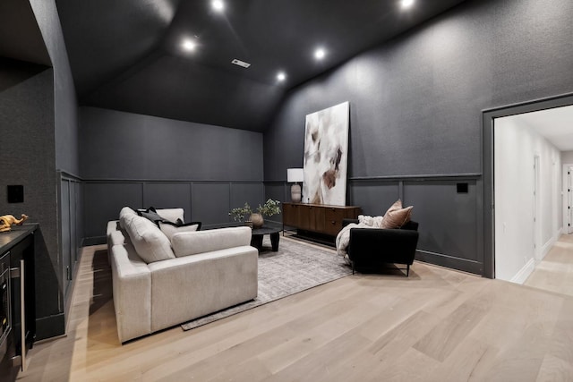 interior space with a towering ceiling and light hardwood / wood-style flooring