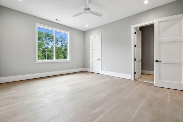 unfurnished bedroom with ceiling fan and light hardwood / wood-style flooring