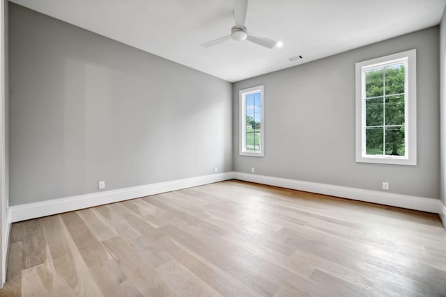 empty room featuring ceiling fan and light hardwood / wood-style floors