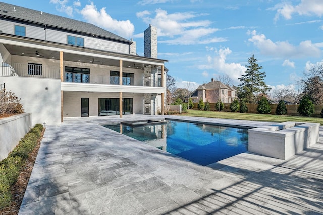 view of pool featuring a patio area, ceiling fan, and a hot tub