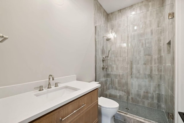 bathroom featuring walk in shower, vanity, and toilet