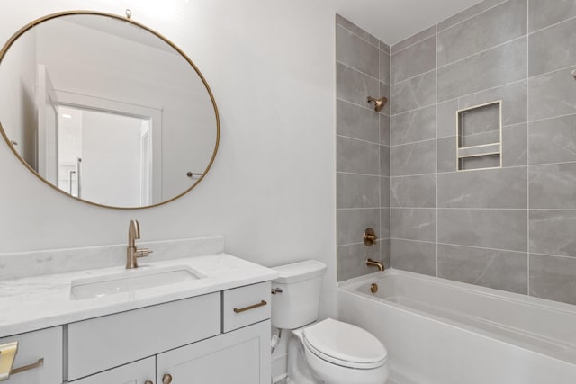 full bathroom with tiled shower / bath combo, vanity, and toilet