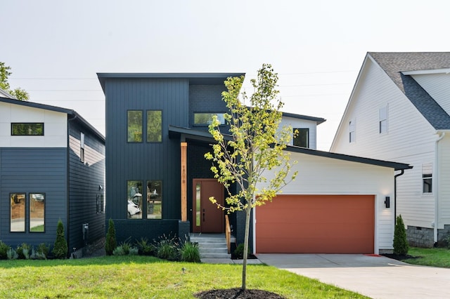 contemporary home with a front yard and a garage